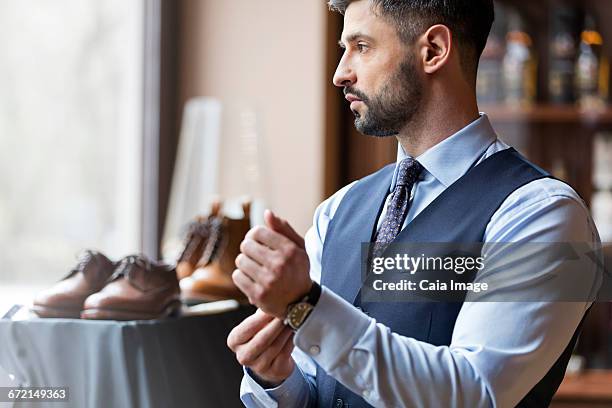 businessman looking through window in menswear shop - シャツとネクタイ ストックフォトと画像