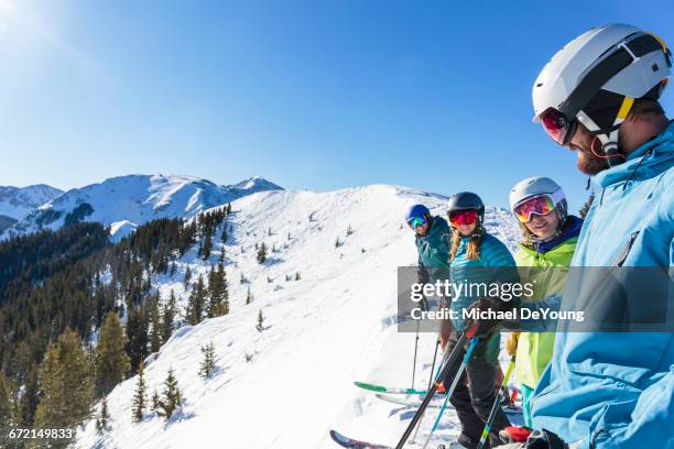 friends on skis standing on snowy mountaintop - taos stock-fotos und bilder