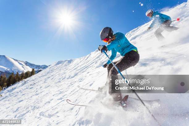 couple skiing on snowy mountain slope - taos new mexico stock pictures, royalty-free photos & images