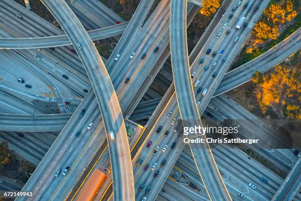 aerial view of highway interchange in cityscape - intertwined stock-fotos und bilder