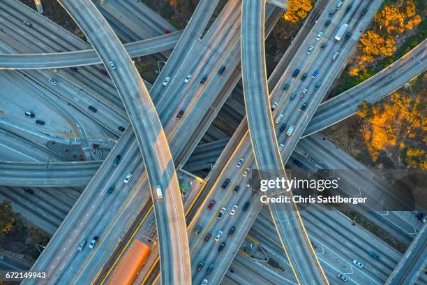 aerial view of highway interchange in cityscape - intertwined stock pictures, royalty-free photos & images