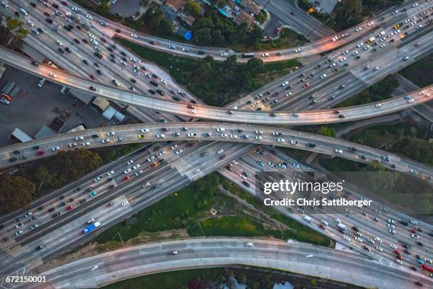 aerial view of highway interchange in cityscape - traffic jam aerial stock pictures, royalty-free photos & images