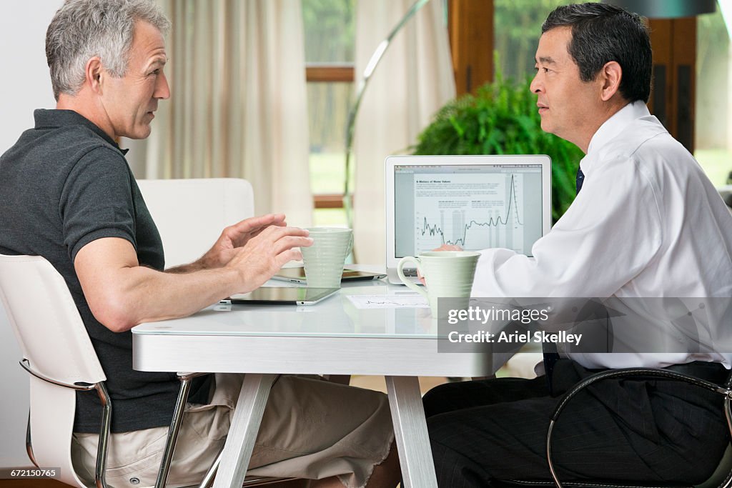Man talking with financial advisor at table