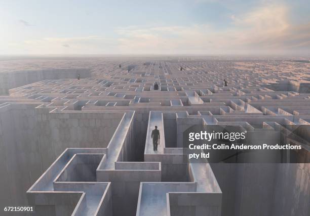 businessmen walking on top of complex maze - rätsel lösen stock-fotos und bilder