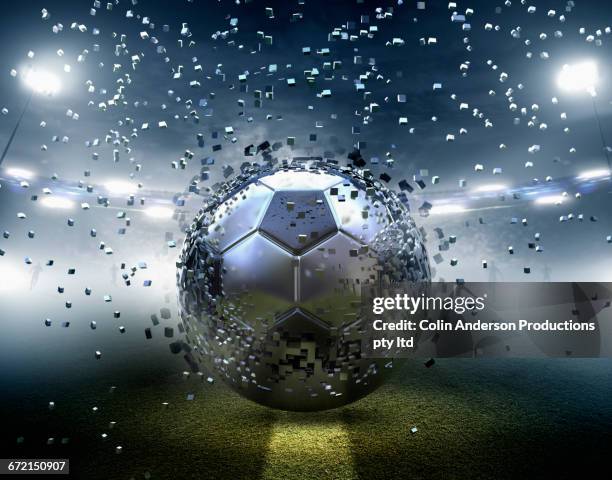 futuristic silver soccer ball exploding into pixels - creative pitch stock pictures, royalty-free photos & images
