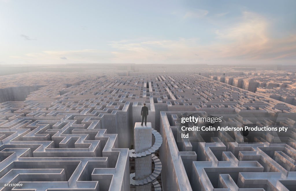 Businessman stranded at top of complex maze