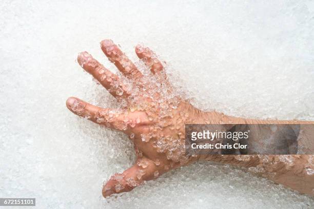 arm of man on ice - freezing hands stock-fotos und bilder