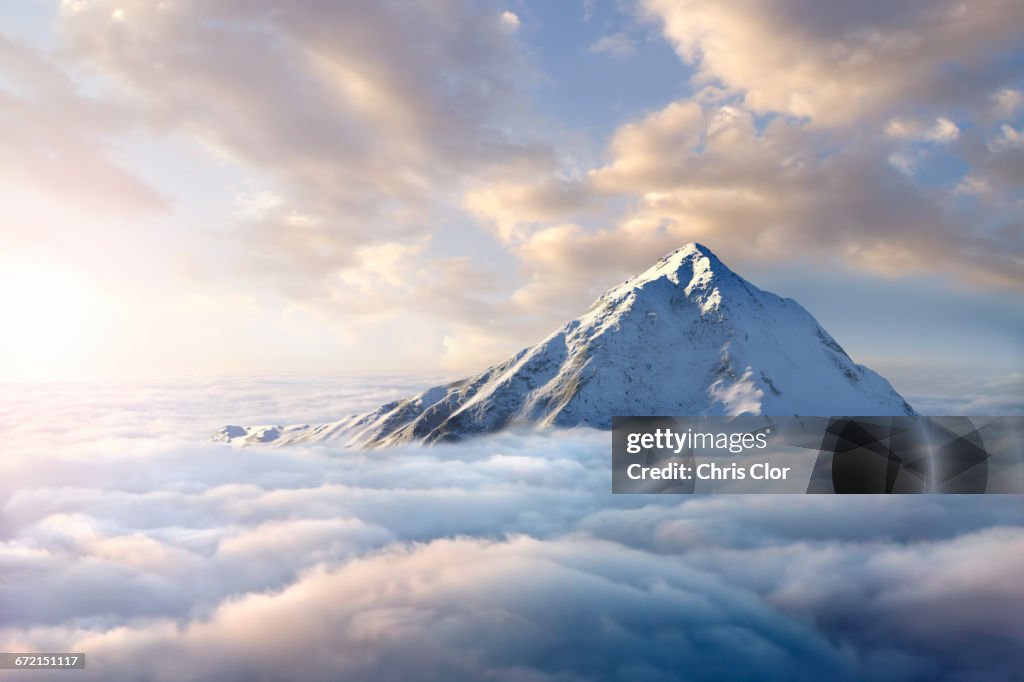 Snow-covered mountaintop above clouds