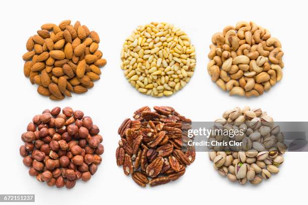 six piles of nuts - almonds isolated stock pictures, royalty-free photos & images