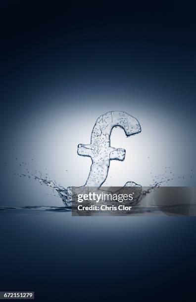 water droplets splashing from ice british pound symbol - freezing motion stock pictures, royalty-free photos & images