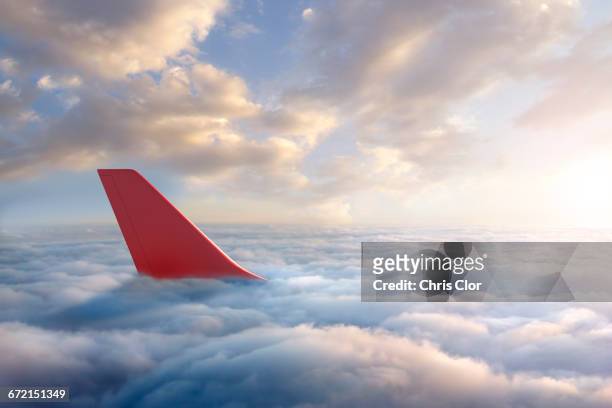airplane rudder above clouds - airplane tail fotografías e imágenes de stock