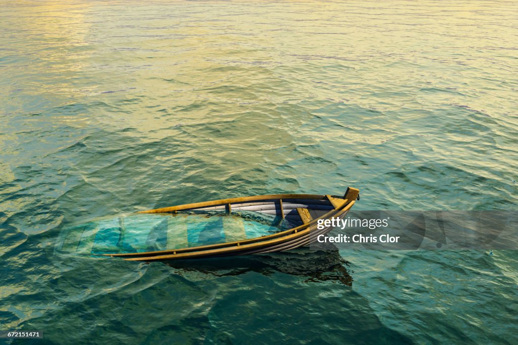Abandoned sinking rowboat in ocean