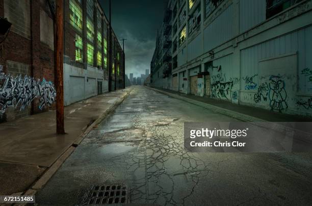 graffiti on walls on empty city street - vicolo foto e immagini stock