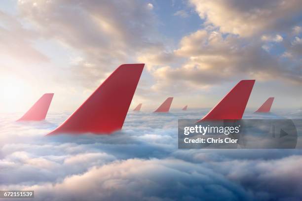 airplane rudders above clouds - airplane tail fotografías e imágenes de stock