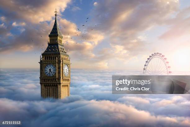 birds flying around clock tower near ferris wheel above clouds - big ben london stock pictures, royalty-free photos & images