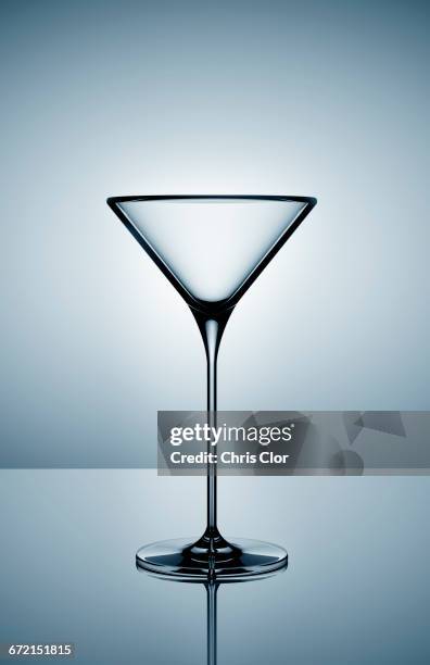 empty martini glass on gray background - martini glass stock-fotos und bilder