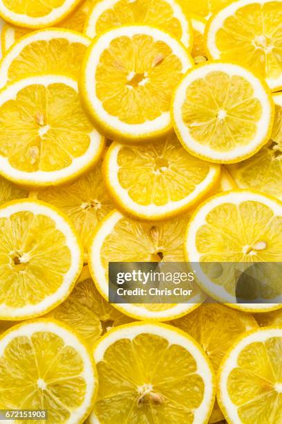 pile of fresh lemon slices - citron stock pictures, royalty-free photos & images