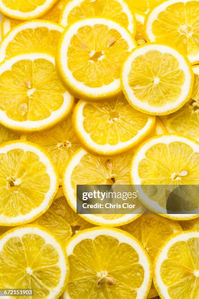 pile of fresh lemon slices - lemon fruit stock pictures, royalty-free photos & images