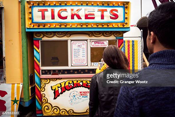 friends waiting in line at amusement park ticket booth - amusement park ticket stock pictures, royalty-free photos & images