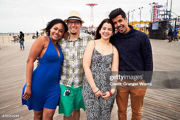 friends posing on boardwalk at amusement park - double date fotografías e imágenes de stock