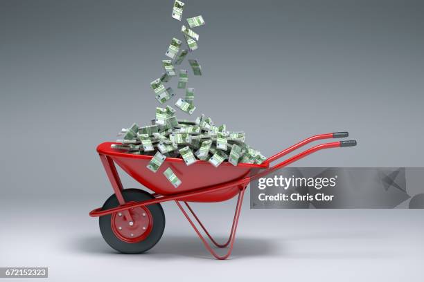 euros falling into red wheelbarrow - the euro 2016 stock pictures, royalty-free photos & images