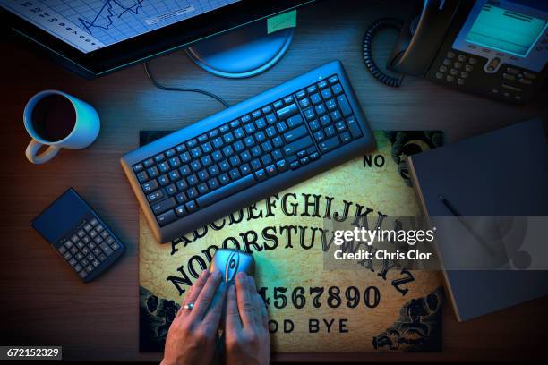 hands using computer mouse on ouija board - ouija board stock pictures, royalty-free photos & images