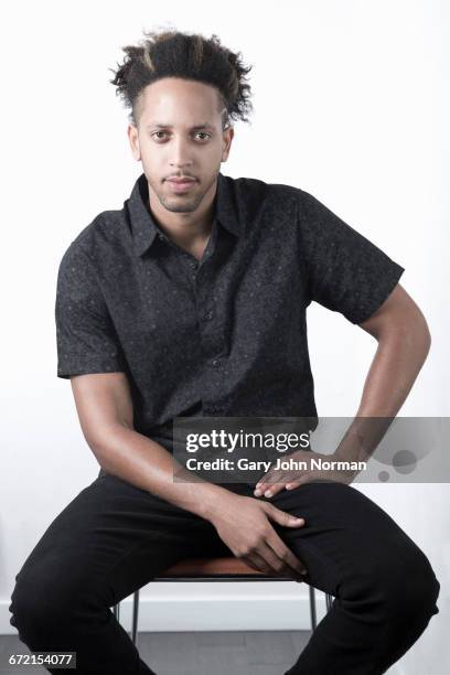 serious mixed race man sitting on chair - real businessman isolated no smile stock pictures, royalty-free photos & images
