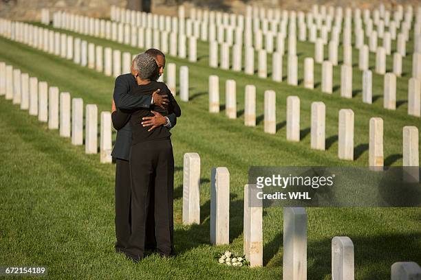 black couple hugging in military cemetery - black women of bond tribute stock pictures, royalty-free photos & images