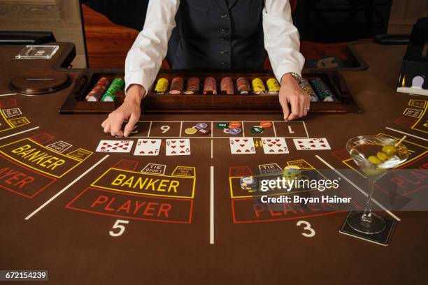 dealer at baccarat table - baccarat table stock pictures, royalty-free photos & images