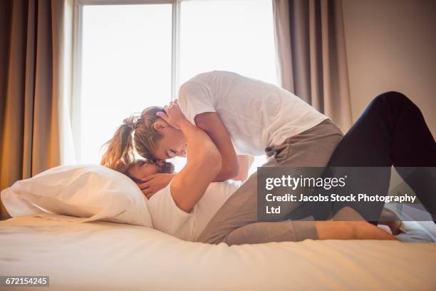 Hispanic Passionate Hispanic Couple Kissing In Bed, Stock-Foto