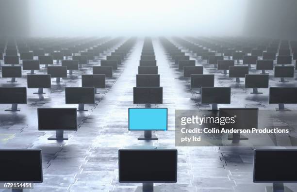 glowing computer monitor in row of monitors - large group of objects stock pictures, royalty-free photos & images