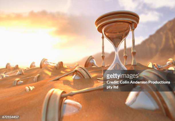 hourglasses buried in sand at beach - time zone stock-grafiken, -clipart, -cartoons und -symbole
