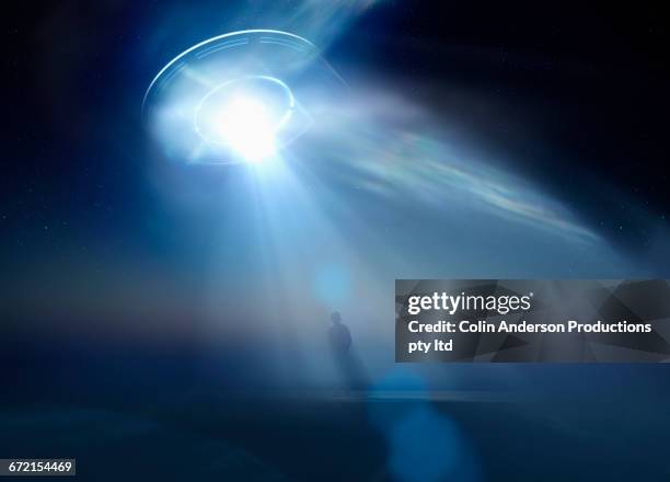 stockillustraties, clipart, cartoons en iconen met caucasian man standing in beam of light from ufo - alien