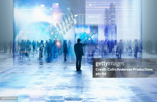 businessman using virtual visual screen in crowd - virtual trade fair stock pictures, royalty-free photos & images