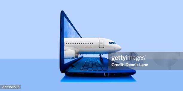 airplane emerging from laptop screen - appearance ticket stock pictures, royalty-free photos & images