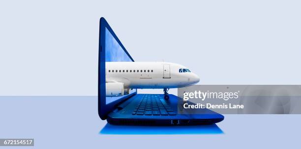 airplane emerging from laptop screen with pilot walking on keyboard - appearance ticket stock pictures, royalty-free photos & images