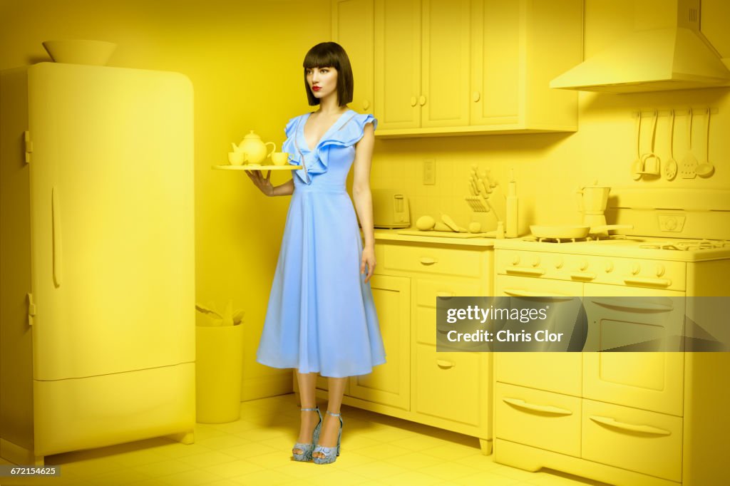 Caucasian woman in yellow old-fashioned kitchen holding mixing bowl