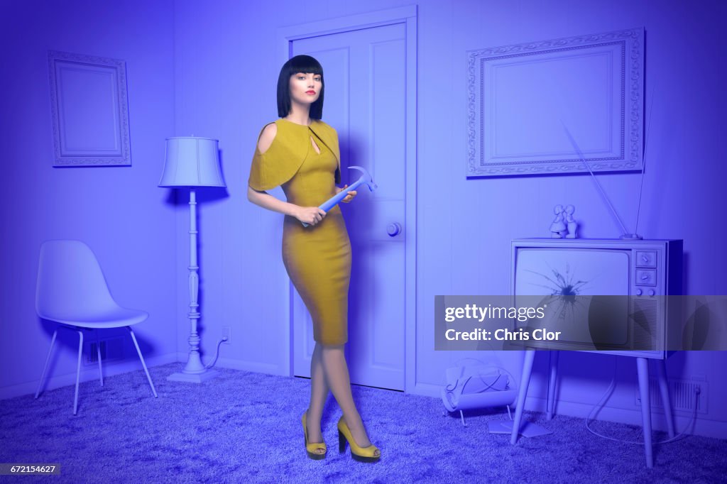 Caucasian woman in purple old-fashioned livingroom holding hammer