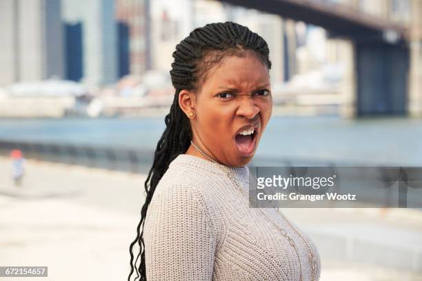 black woman with disgusted attitude at waterfront - angry black woman stock pictures, royalty-free photos & images
