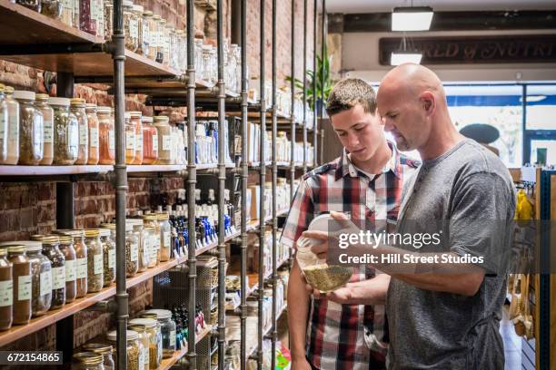 customers browsing in nutrition store - teenager boy shopping stock-fotos und bilder