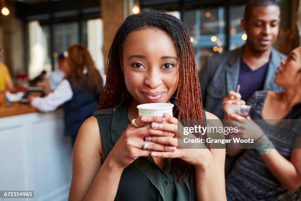 smiling woman drinking coffee in cafe - incidental people stock pictures, royalty-free photos & images