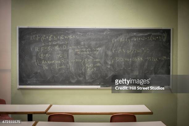 equations on blackboard in classroom - chalkboard stock pictures, royalty-free photos & images