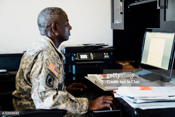 black soldier using computer - military computer stock pictures, royalty-free photos & images