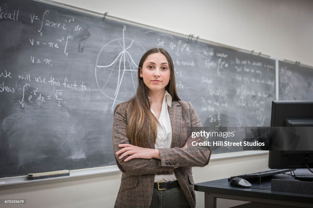 Caucasian woman with arms crossed in classroom