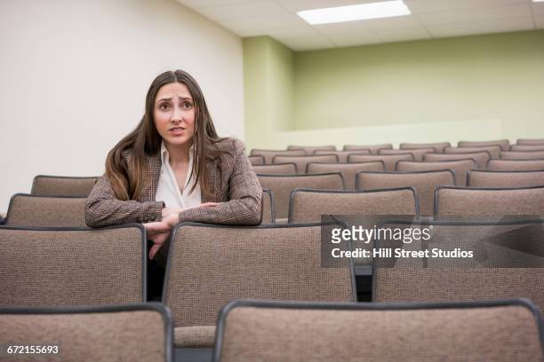 worried caucasian woman leaning on chair in classroom - tensed idaho stock pictures, royalty-free photos & images