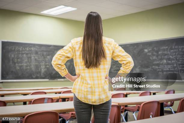 caucasian woman standing with hands on hips in classroom - caldwell idaho stock pictures, royalty-free photos & images