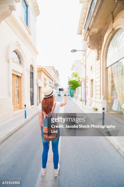 caucasian woman photographing with cell phone in street - limassol photos et images de collection
