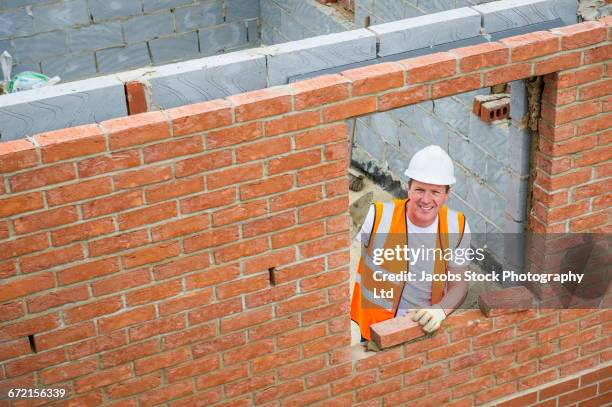 caucasian construction worker laying bricks with mortar - mason bricklayer stock pictures, royalty-free photos & images