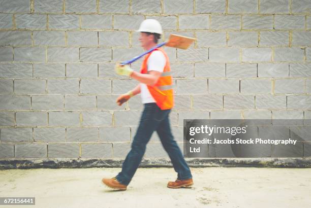 caucasian construction worker carrying shovel - spalding place bildbanksfoton och bilder