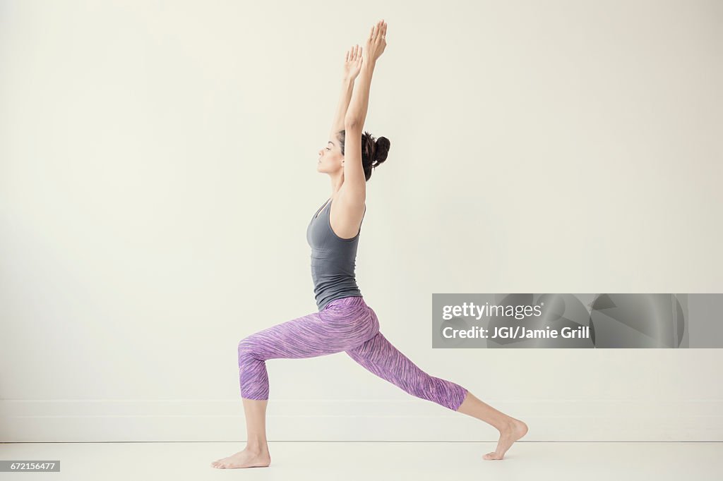 Indian woman with arms raised yoga pose
